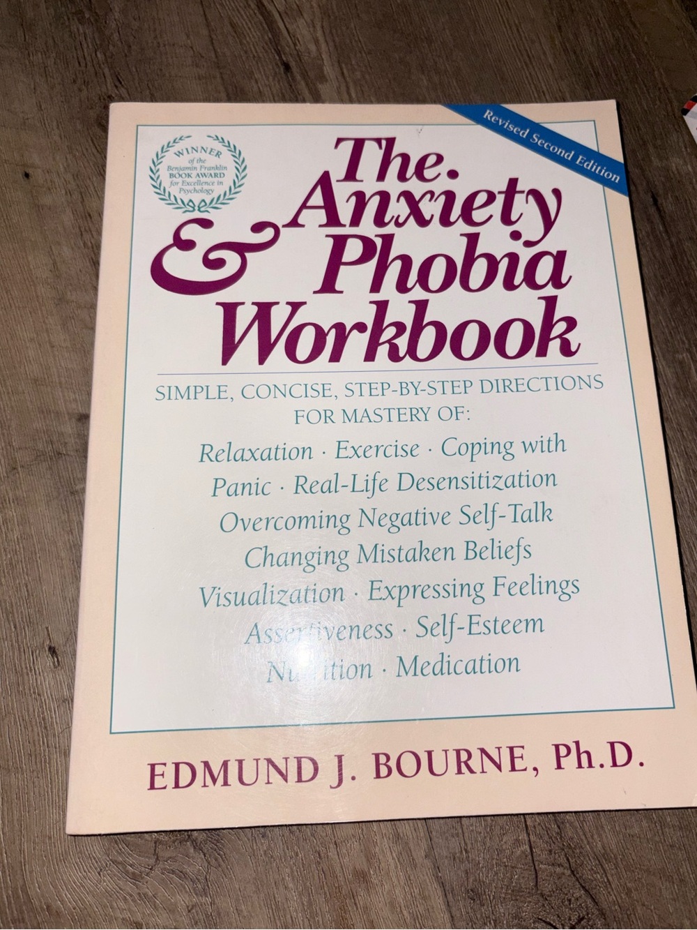The Anxiety & Phobia Workbook by Edmund J. Bourne - Cream & Burgundy Cover